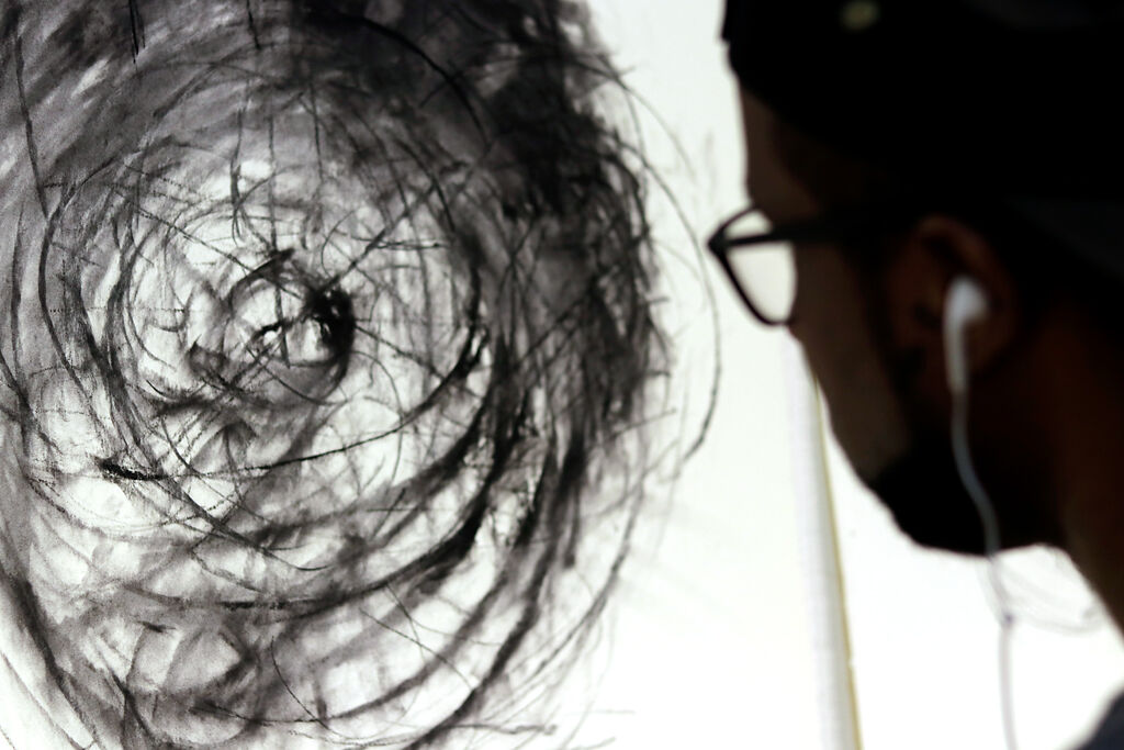 Askia Bilal works on a piece